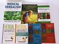 Photo showing seven herbalism books including Medical Herbalism, The Herbalist's Way, Adaptogens, Herbal Antibiotics, Herbal Antivirals, and two volumes of A Modern Herbal.