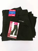 Folded black Stormpack ladies snowpants with size Large tag visible.