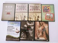 Top view of all seven DVDs showing covers for religious instruction, children's music, health, and ballet workouts
