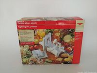 Box of World Cuisine plastic turning slicer showing product image and text in multiple languages.