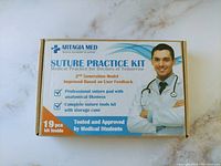 Box packaging of the suture practice kit showing brand Artagia Med and features of the kit