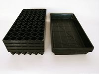 Stack of four black Winstrip seedling trays showing the unique cell structure designed for air pruning.