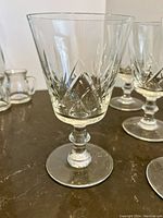 Close-up of one crystal red wine glass showing diamond cut pattern and clear crystal with rounded segmented stem and round base