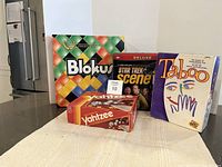 Four board games displayed on table: Blokus, Star Trek Scene It Deluxe, Yahtzee, and Taboo.