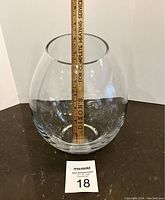 Clear rounded crystal vase approximately 9 inches tall next to a ruler showing size.