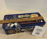 Blue metal O-Pee-Chee collector's tin with NHL goalie image and product information showing 2002-03 NHL hockey cards complete set with 330 base cards and backs.