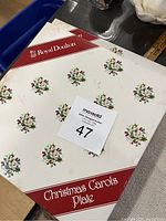 Photo of the closed original Royal Doulton Christmas Carols plate box with branding and title visible