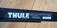 Close-up of the Thule brand logo and registration number on the bike rack.