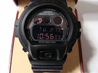 Front view of Casio G-Shock 3230 DW-6900 MS digital watch with black negative display showing time and date.