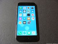 Front view of space grey iPhone 6 showing home screen with apps.