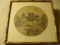 Circular Japanese landscape print on silk with bamboo-style frame, showing overall condition and framing.