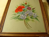 Full view of framed oil painting of floral bouquet on board, signed by Vicky J.