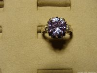 Top and angled view showing purple stone and setting