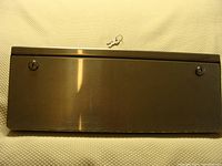 Front view of stainless steel lock-up box showing two key locks and included key above center.