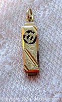 Front view of yellow gold mezuzah pendant showing textured, diamond cut finish and Hebrew letter detail