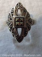 Front view showing elongated openwork design and marcasite centerpiece