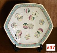 Top angled view of vintage Asian pottery bowl showing hexagonal shape and floral-geometric painted design