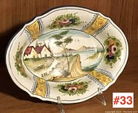 Front view of the oval vintage Italian majolica bowl showing the full hand-painted scenic and floral design.