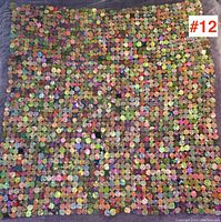 Full view of the colorful penny blanket throw showing the patterned grid of fabric penny circles in multiple colors and overall shape.