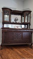 Front view of antique wood buffet and hutch