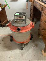 Front angle view of Rigid wet dry shop vacuum showing brand label and capacity details.