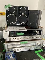 Two silver-face receivers stacked with JVC and Dual speakers on top.