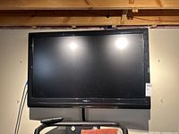 Front view of 42 inch Insignia television mounted on wall, showing the entire screen and surrounding bezel