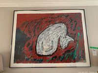 Full view of framed artwork showing red and green abstract background with central white form