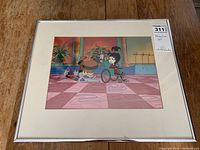 Full view of the framed animation cell with cream mat and silver frame showing two Beetlejuice characters in a scene.