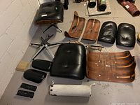 All disassembled components laid out: shells, cushions, bases, hardware and neck roll