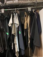 Rack of assorted women’s clothing (coats, tops, scarves, jackets)