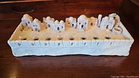 Front view of the handmade ceramic menorah showing architectural details and candleholder glass inserts
