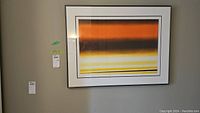 Full front view of framed abstract print on wall with lot tags.