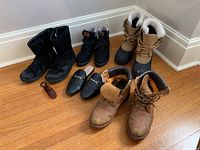 Full group photo of five pairs of women's shoes and boots on wood floor showing lot contents