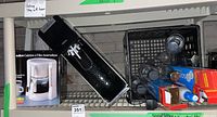 SodaStream bottles and accessories in a black basket with Salton coffee maker box on nearby shelf.