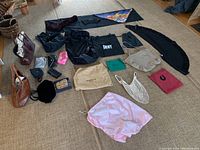 Overview of all women's accessories laid out on floor to show variety and quantity, including purses, bags, scarves, and pouches.