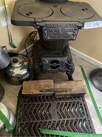 Full view of cast iron stove, grates and bricks