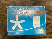 Front of the box showing the Blade LED Bulb 5+1 fan bulb, highlighting the product design with five light blades and one small fan blade.