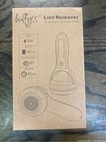 Cardboard box packaging showing Bufyss brand fabric shaver lint remover with technical specs including power, battery, rotating handle angle, and usage time.