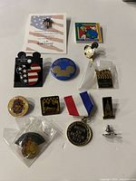 Full display of all 12 Disney collectible pins including Airship Mickey, Indy 200, Pluto's Pursuit, and others, showing condition and variety.