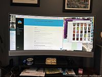 Monitor in use showing ultrawide curved screen displaying multiple windows