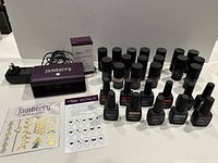 Full lot including curing light, power adapter, 17 TruShine gel bottles, 11 Colour Cure gel bottles, and nail art sticker sheets on display.