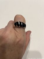 Ring worn on hand showing size and scale with the black onyx ribbed inlay design.