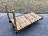 Front angle showing slatted wooden deck and two push handles