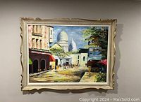 Framed vintage oil painting showing street scene with people and domed buildings in background