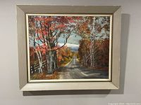 Frontal view of the framed oil on board painting showing a detailed autumn road landscape with colorful foliage and a partly cloudy sky.
