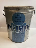 Front view of the vintage Primex lard advertising tin showing the brand name, use for frying and shortening, and target market.