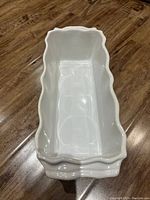 Top view showing the interior and scalloped edge design of the white ceramic oven dish.