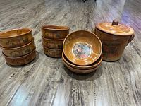 Overview photo showing three stacks of bowls and a lidded serving dish, all ceramic with Italian kitchen illustrations in warm brown tones.