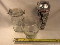 Photo of all three items together: metal cocktail shaker, glass vase, and glass jar with metal clasp.